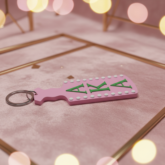 AKA paddle keychain styled on pink velvet with gold accents