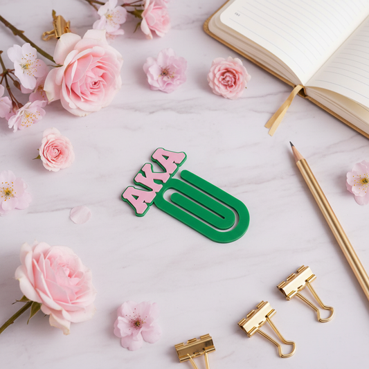 AKA paperclip bookmark styled on pink marble with flowers and gold stationery accents
